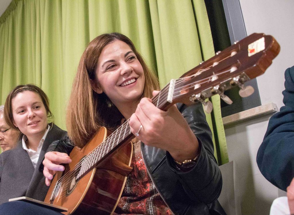 Young Franciscan on guitar